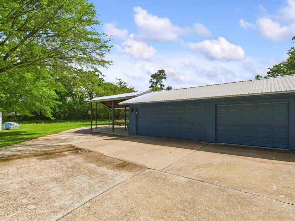 Private circle driveway and plenty of parking with a 3 car garage and carport!