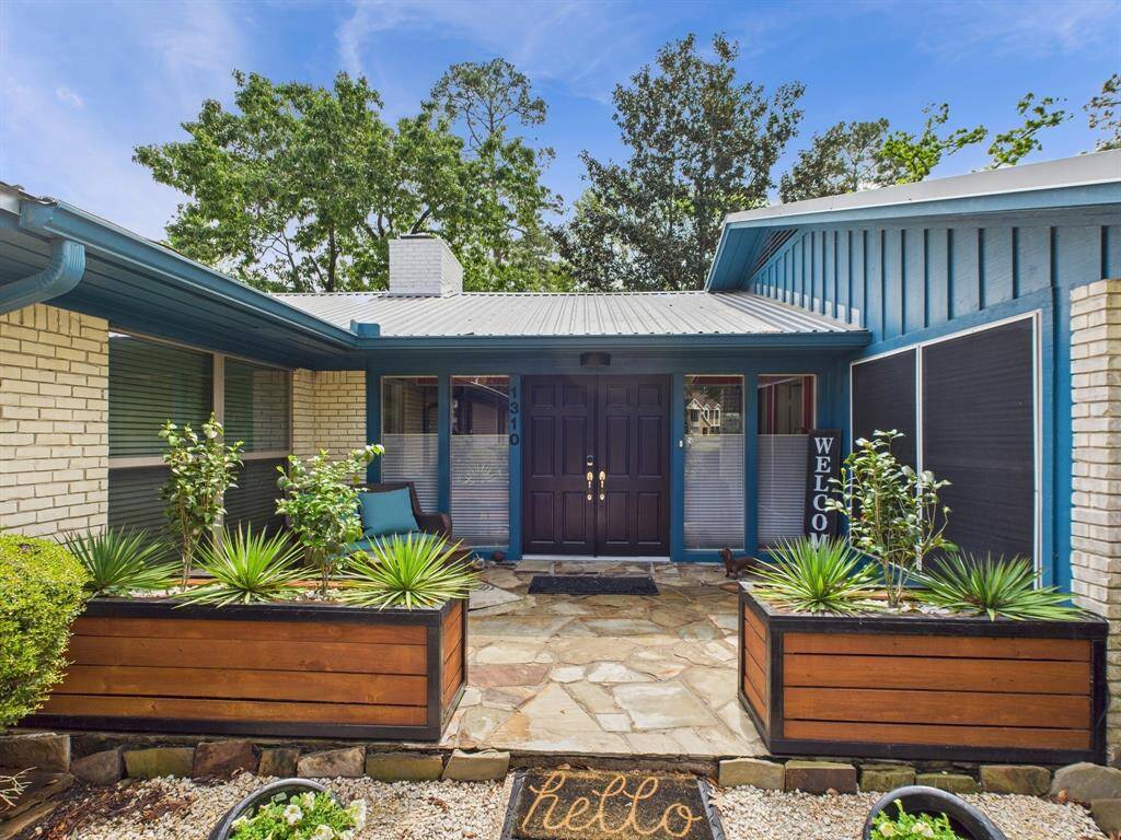 Front entrance with new planter boxes for a cozy porch setting.