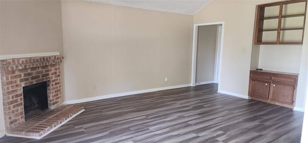 Another view of the large den with builtins.  Coat closet in front entry way,