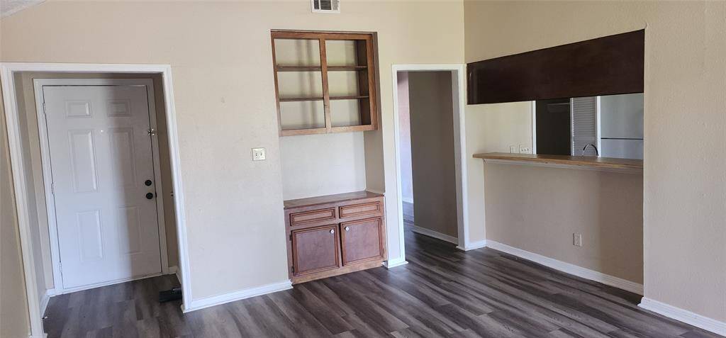Another view of the large den with builtins.  Coat closet in front entry way,