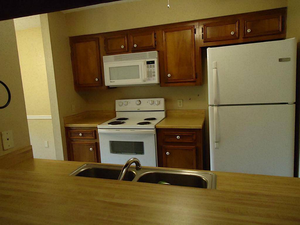 Kitchen includes refrigerator, dishwasher, range & microwave