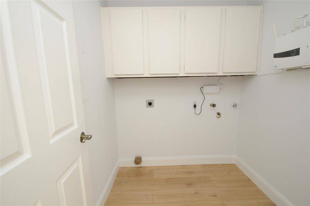 Laundry room with ample cabinet storage.