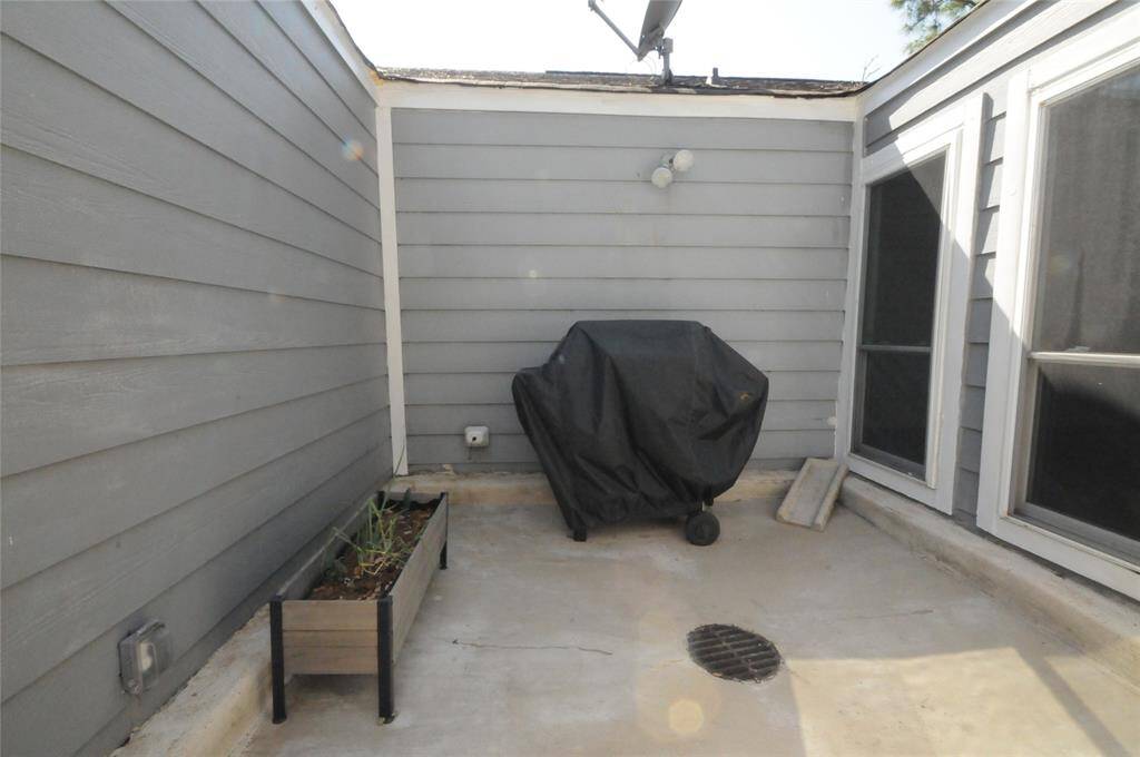 Cozy atrium off the breakfast room, perfect for grilling and outdoor dining.