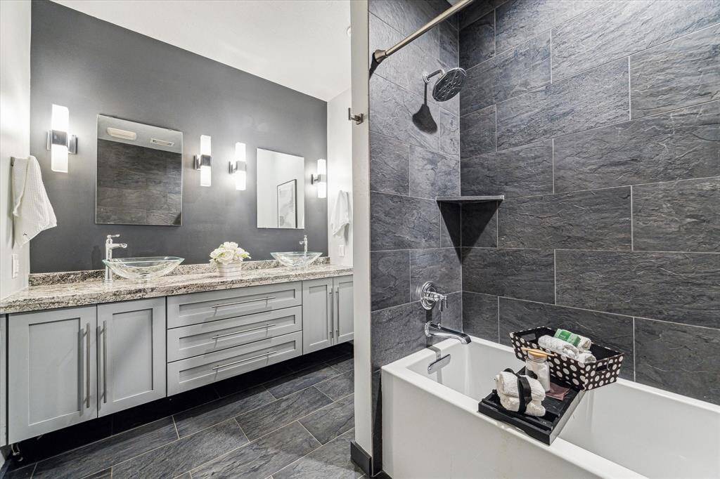 The secondary bathroom with a deep soaking tub and beautiful finishes.