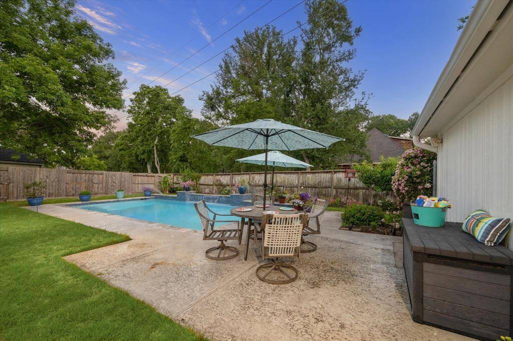 The pool area looks out to a pretty green space.