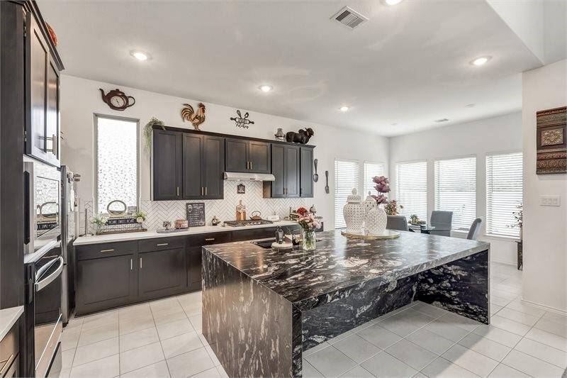 Kitchen with stunning Quartize waterfall island!