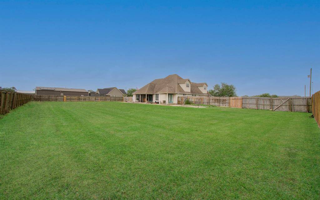 Additional land behind fence.