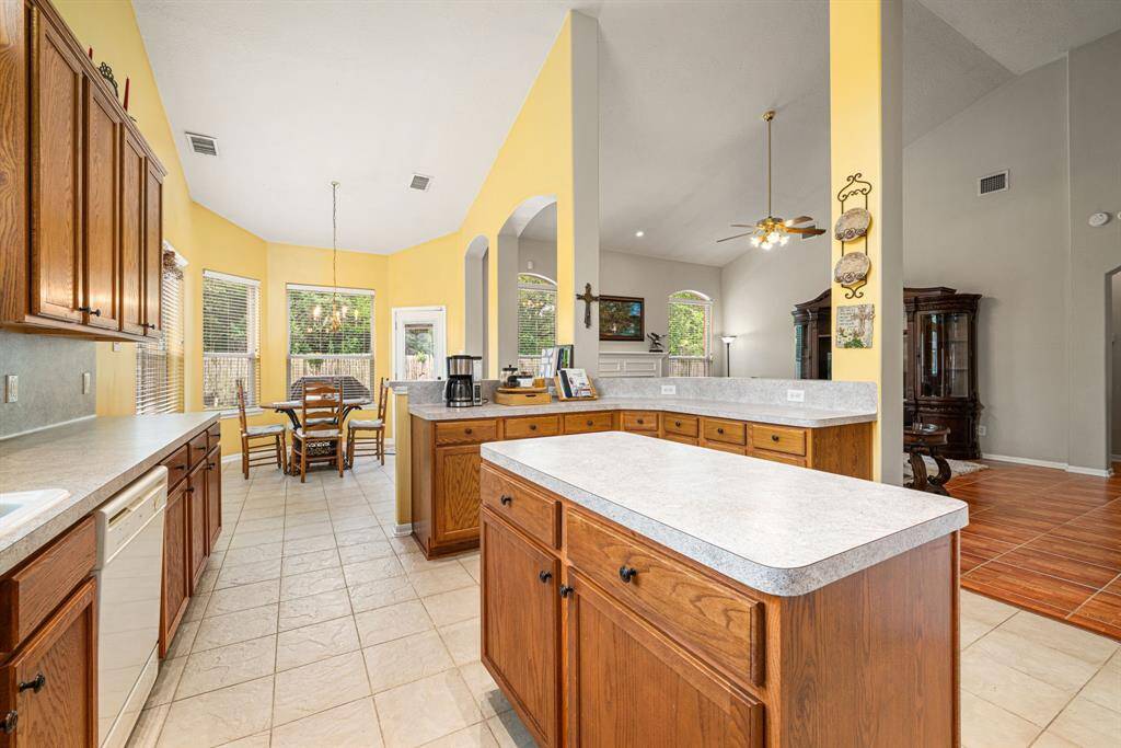 Island kitchen and breakfast room opening to the family room