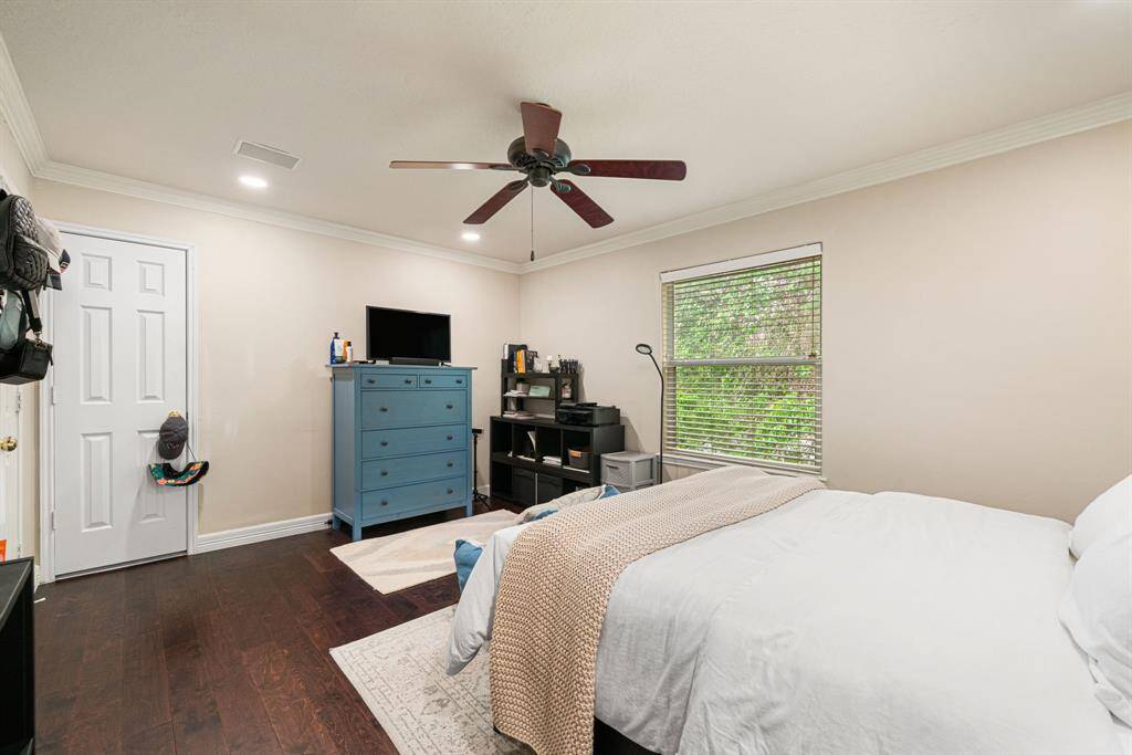 This spacious 2nd bedroom features hardwood floors, ceiling fan, and