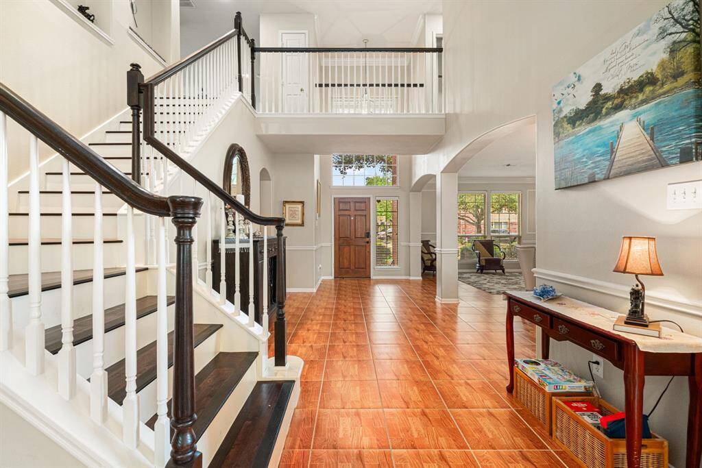 The focal point staircase with dark wood flooring is a showstopper from any angle!