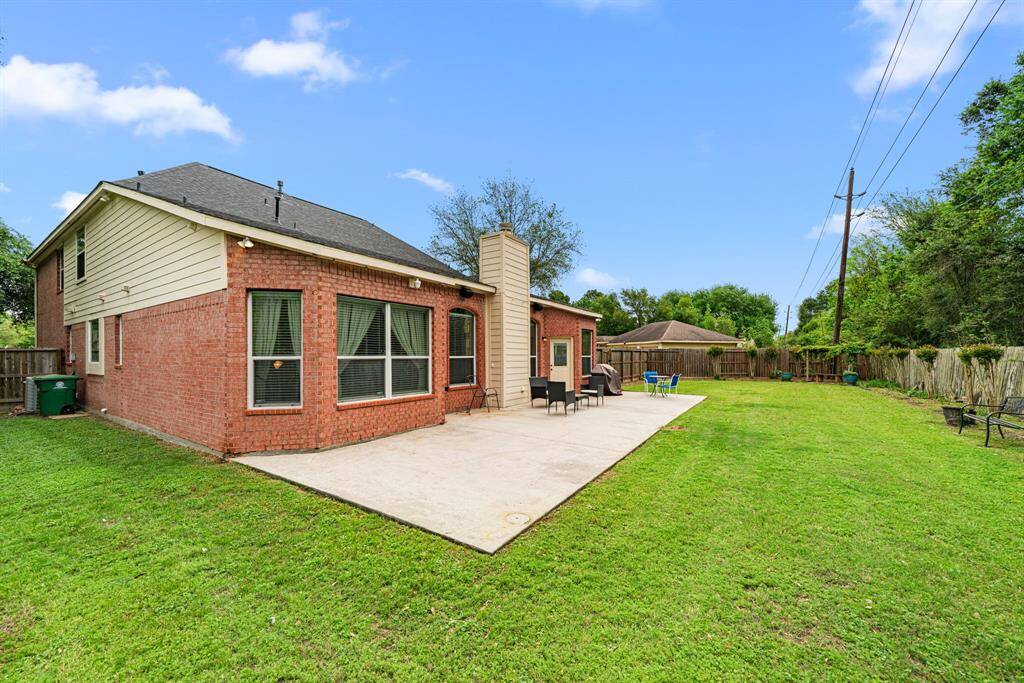 This expansive backyard offers a flexible space with room for a playground, pool, and many options