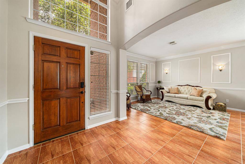 Stepping through the front door, this spacious entryway and wonderful brightness of the home welcome you from the start.
