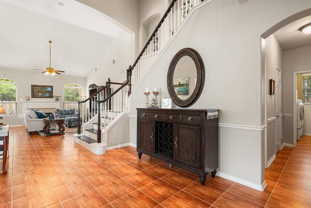 Lovely tile flooring flows throughout the broad entryway, formal dining/living, and family rooms