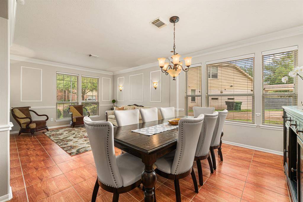 The formal dining room boasts space for a large table and lovely decorative chandelier