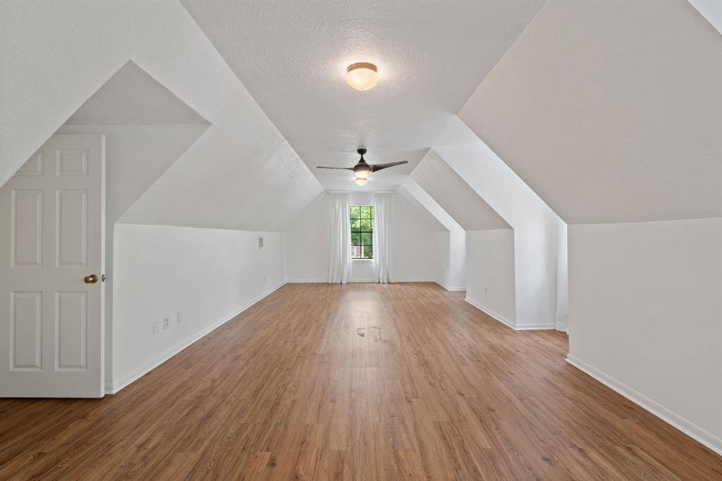 A generously sized fourth bedroom offers flexibility for guests, a home office, or extra living space.