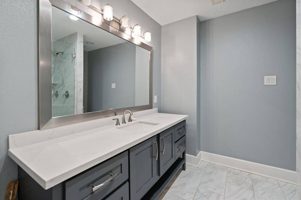 Updated secondary bedroom blends modern finishes.