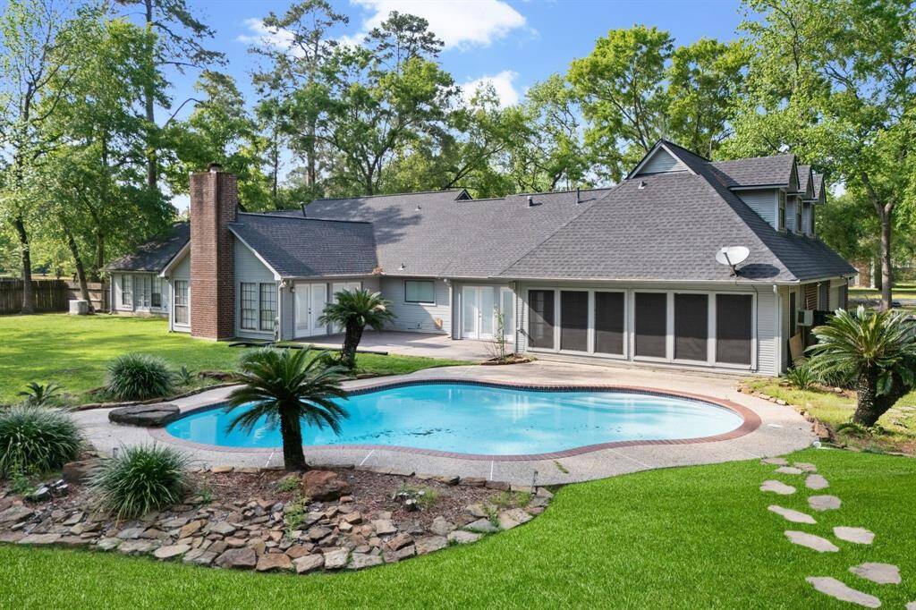 Your private retreat awaits! This stunning home features a well-maintained pool surrounded by greenery.