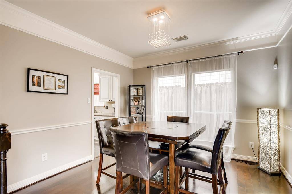 Dining room with wood floors - doorway to the left leads to kitchen