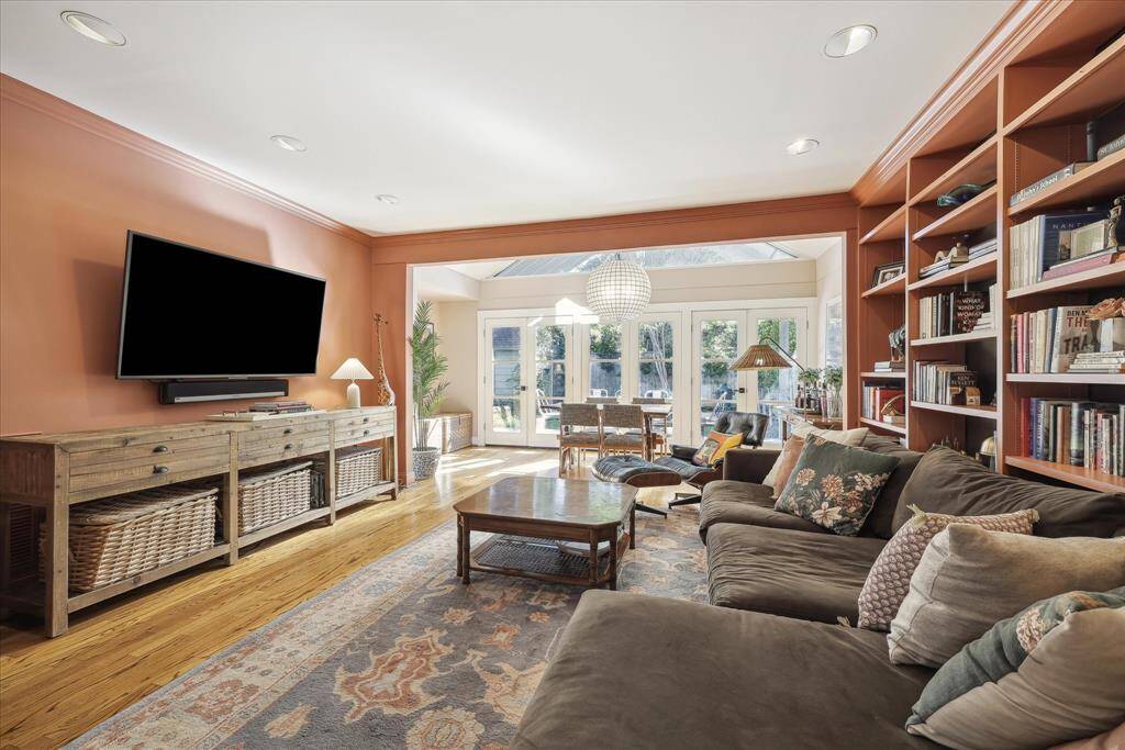 Another view of Family Room with versatile space in the background leading to backyard.