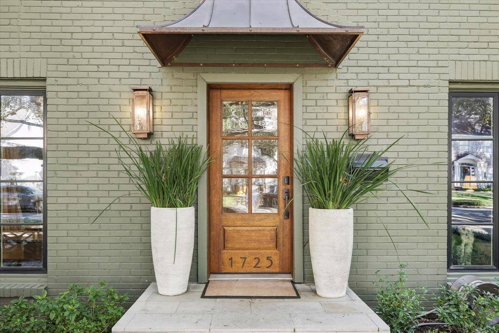 Warm and inviting front entrance with custom copper awning.