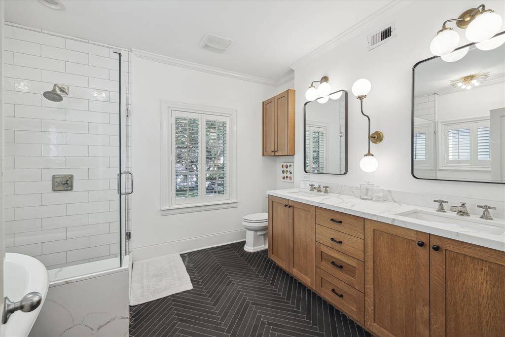Primary Bathroom fully remodeled in 2017* features double sinks, walk-in shower, and soaking tub.
