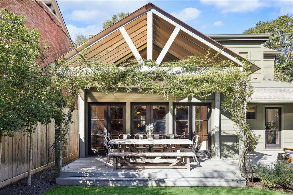 Covered patio with a wooden deck that was added in 2022*. Perfect outdoor dining space! (*=per seller).