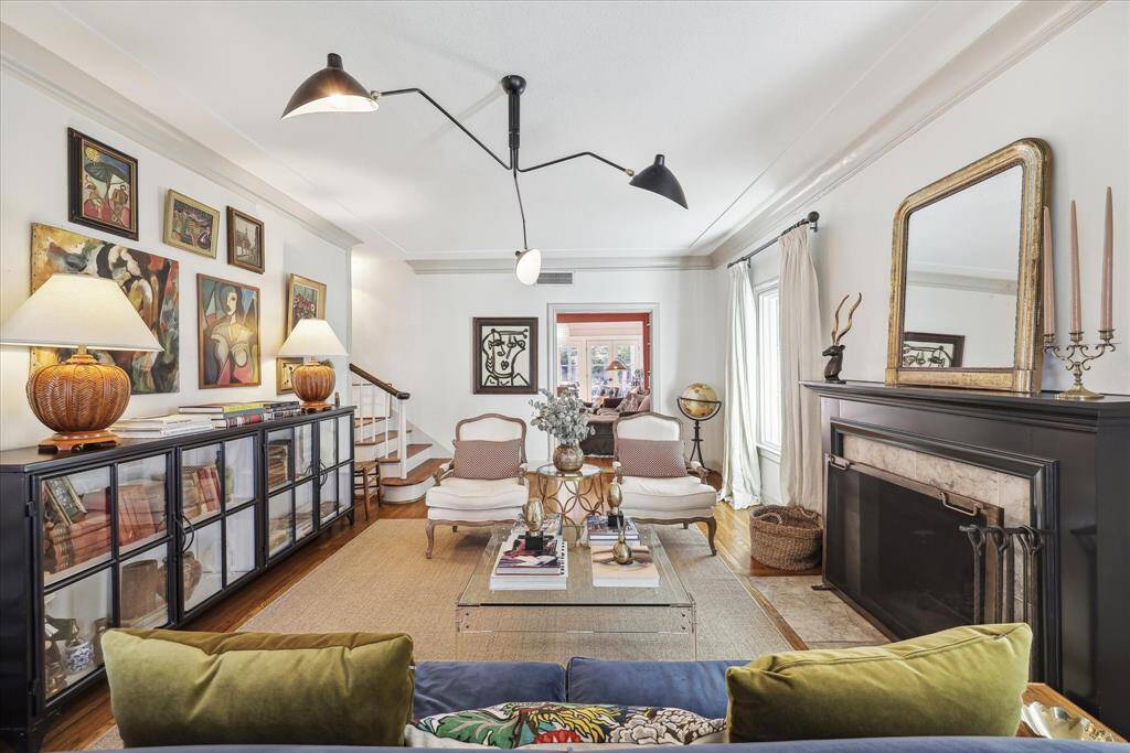 Well appointed formal living space with wood burning fireplace and large windows.
