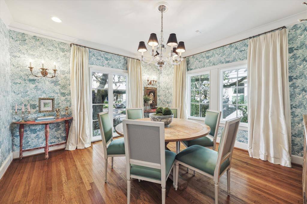Formal dining with hardwoods and recessed lighting. Cole & Son wall covering and custom dupioni silk drapery.