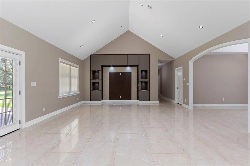 Formal living space features vaulted ceilings and builtins.