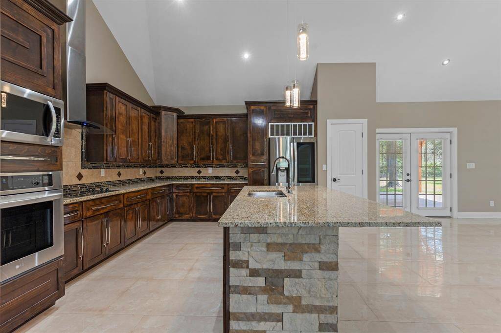 SS appliances include built-in microwave, convection oven, electric cooktop, and refrigerator with insta view see through window.