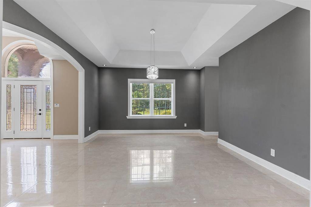 Formal dining off the front entry with vaulted ceilings.