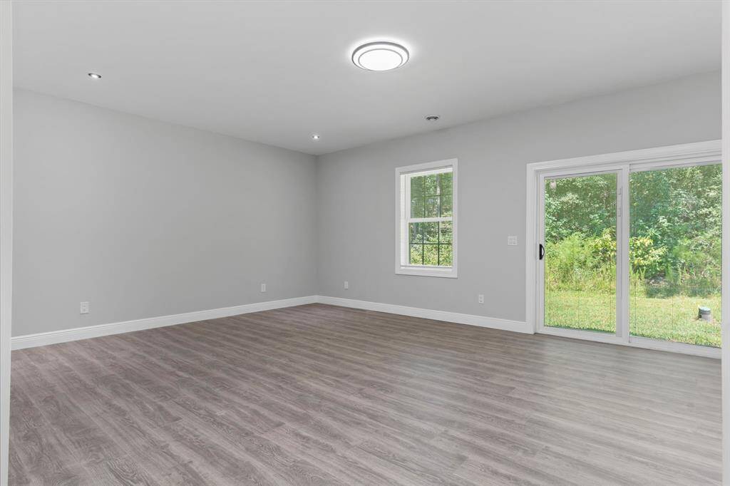 Bedroom with back yard access sliding glass door.