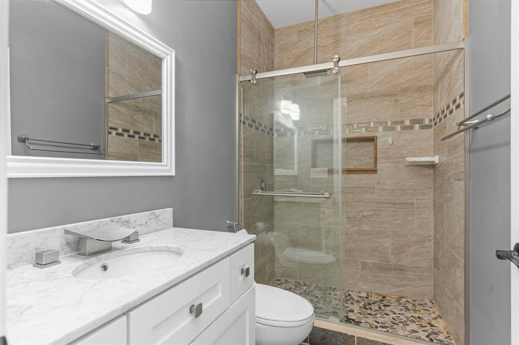 Secondary bathroom featuring a walk in shower.