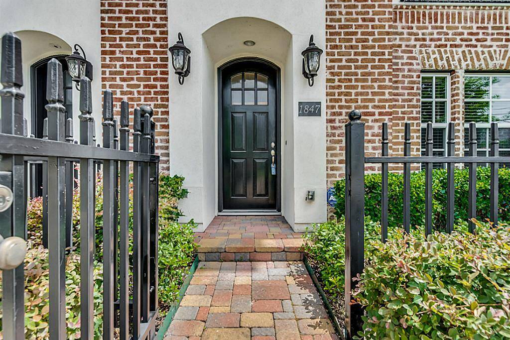 Pedestrian gate to the front door with lush landscaping.