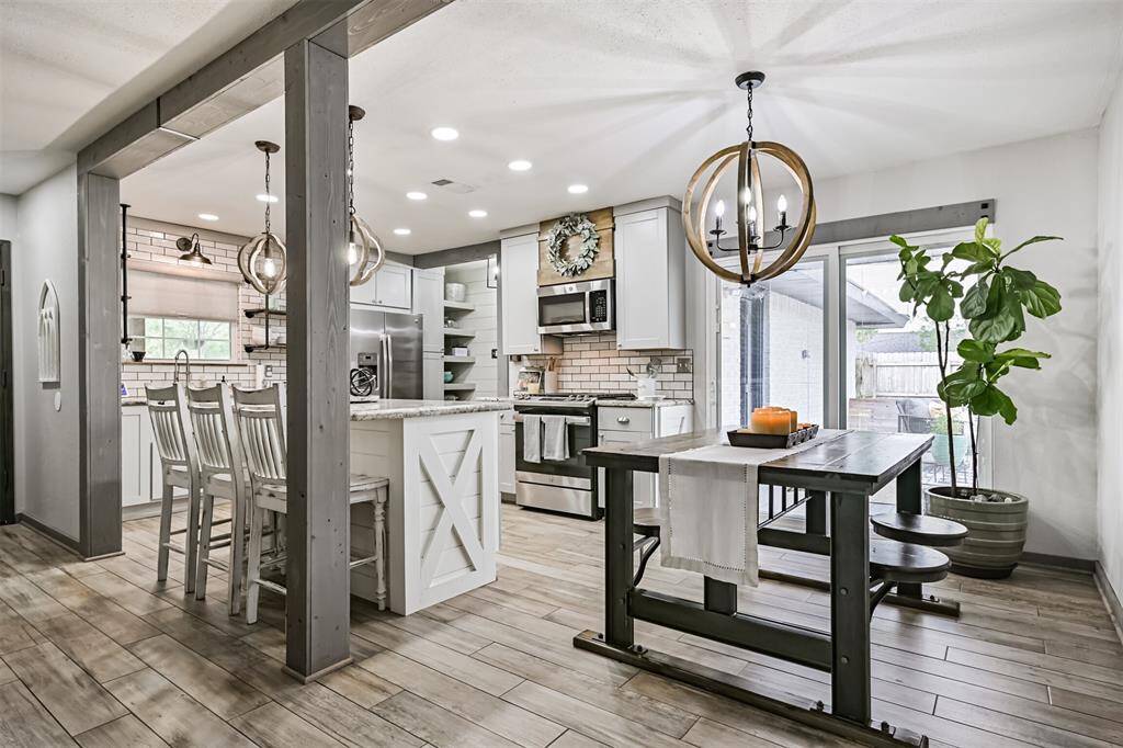 The living room flows into a completely redesigned kitchen, where modern upgrades and thoughtful details create a perfect space for cooking, hosting, and everyday comfort.