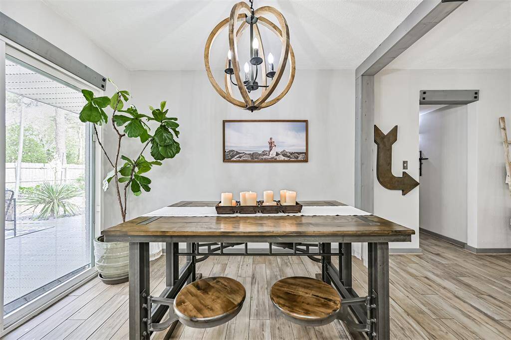 Charming breakfast room features a sliding glass window with views of the backyard—bringing in natural light and offering easy indoor-outdoor dining vibes.