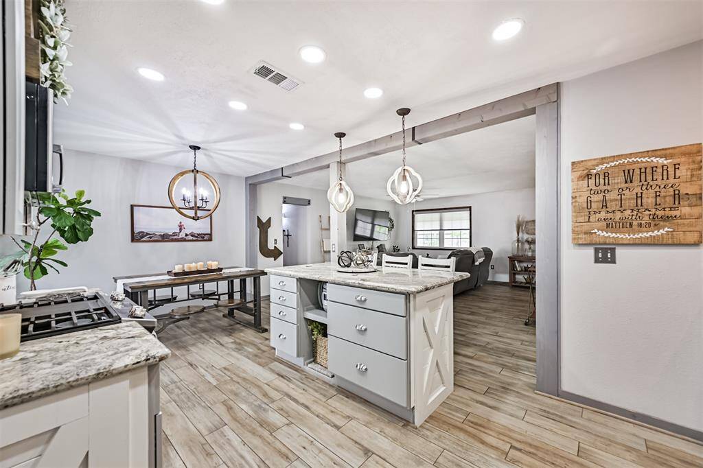 The kitchen island is equipped with convenient pots and pan drawers, offering easy access and organized storage for your cooking essentials, making meal prep a breeze.