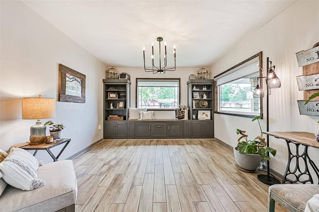 The office features built-in shelving and cabinets, providing ample storage and organization, while the picture windows frame beautiful views and flood the space with natural light—creating an ideal environment for work or relaxation