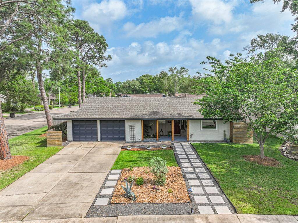 Meticulously landscaped with stepping stones, black gravel, river rock, re-painted on a massive corner lot.