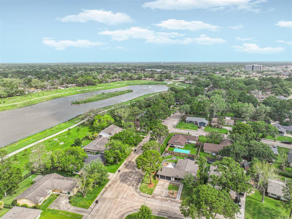 This aerial shot highlights the home's prime location near Exploration Green in Clear Lake, Texas—offering serene views of lush green spaces, walking trails, and a vibrant natural environment right at your doorstep.