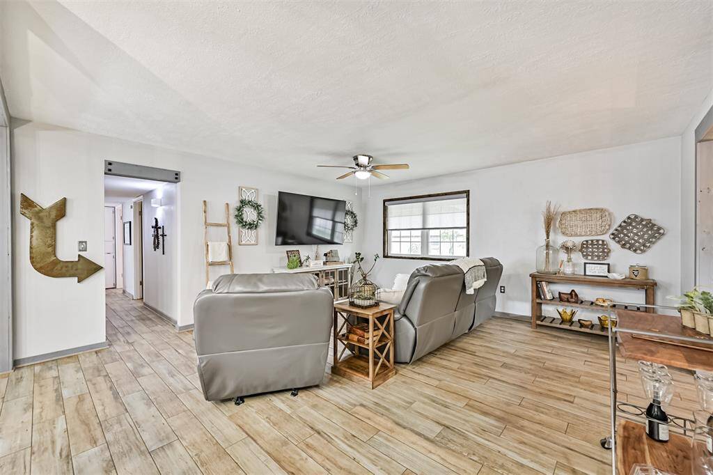 Bright and inviting living room features fresh finishes, retextured ceilings, and an open layout that feels both cozy and spacious.