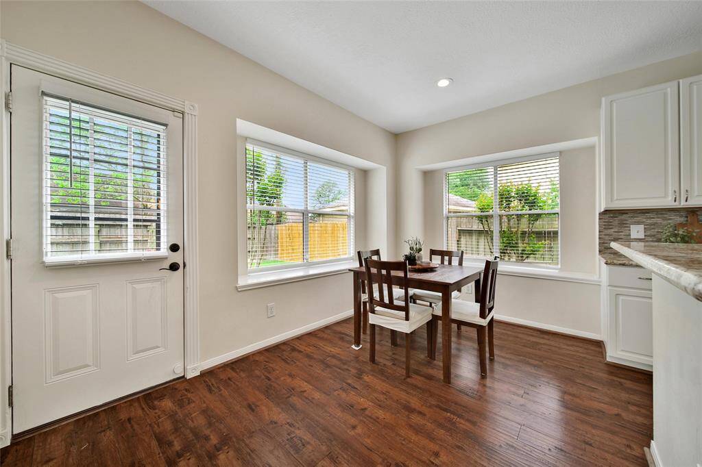 Window seats in the large windows surrounding the dining area are perfect for plant or pillows to customize the space.