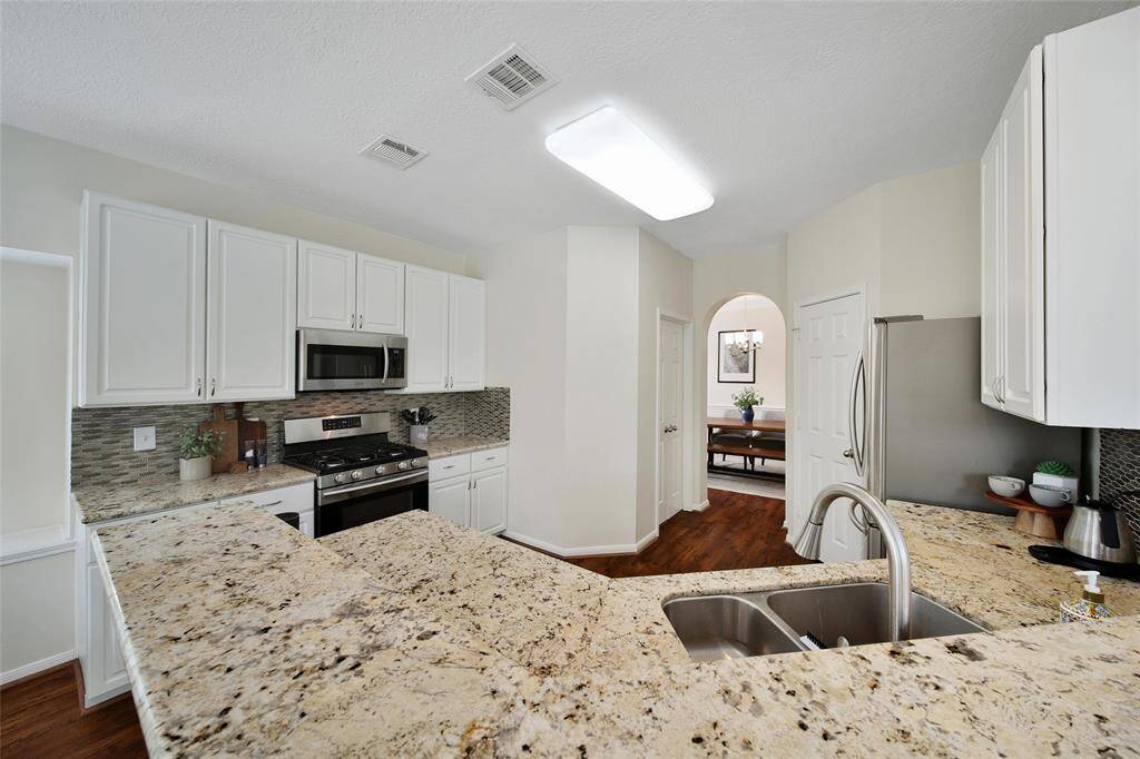 Granite counters with plenty of space make this kitchen easy to work in.