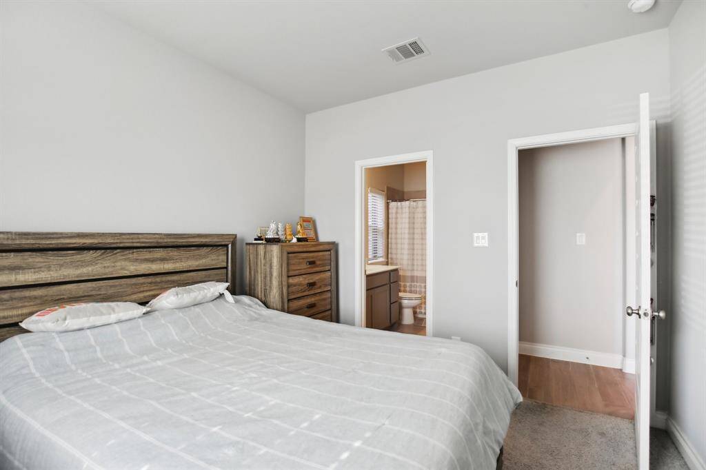 Guest Bedroom: This inviting guest bedroom features a spacious walk-in closet and a generously sized full bath, offering comfort and privacy for your guests.