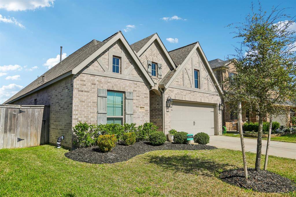4 Side Brick, central gable showcases a striking herringbone brick pattern, adding visual interest and texture to the front elevation.