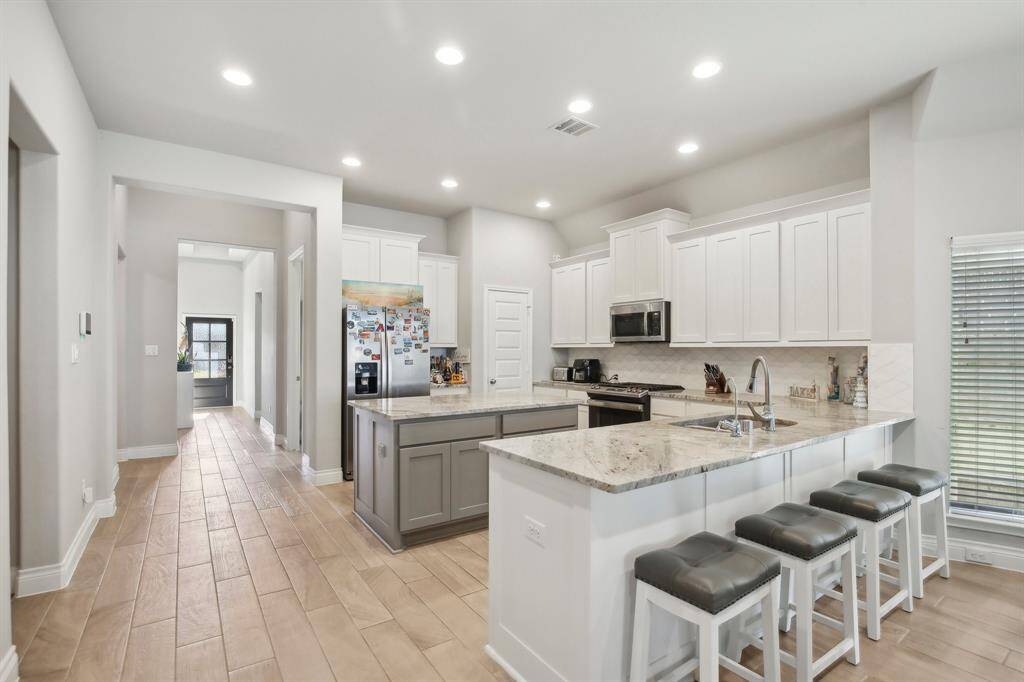 Open Concept Kitchen, This space effortlessly transitions into the heart of the home