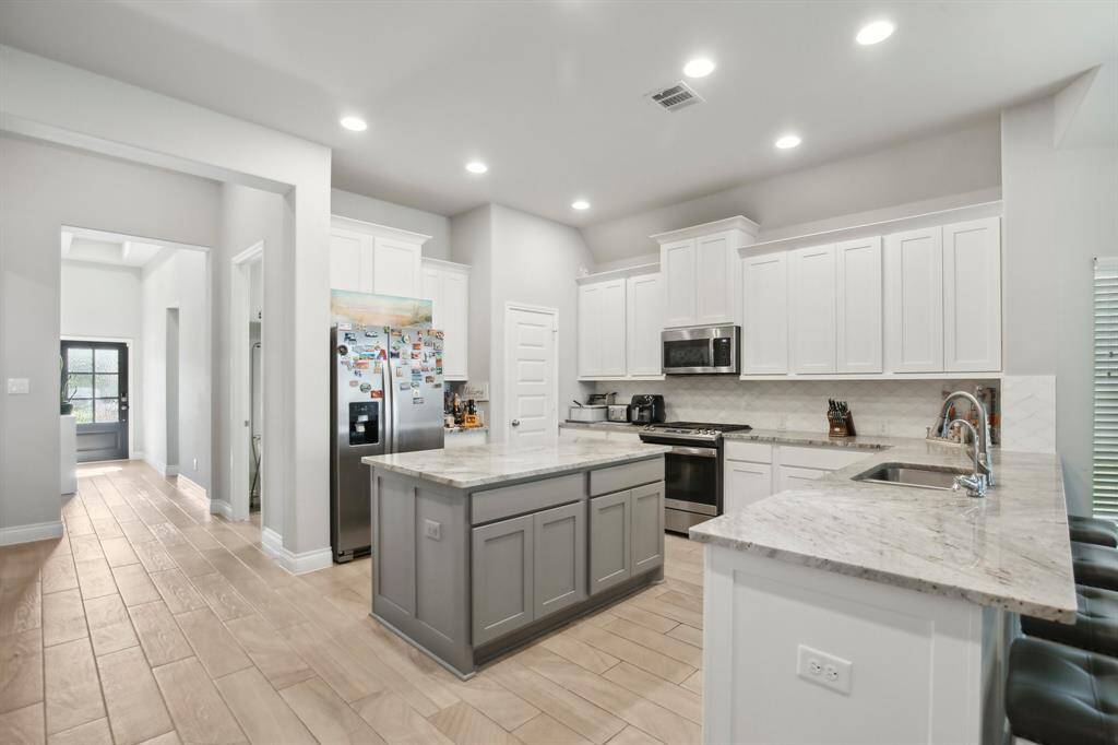 Alternate View of the Expansive Kitchen Island: This angle offers a closer look at the generous center island, a central feature that enhances both the functionality and flow of the kitchen.