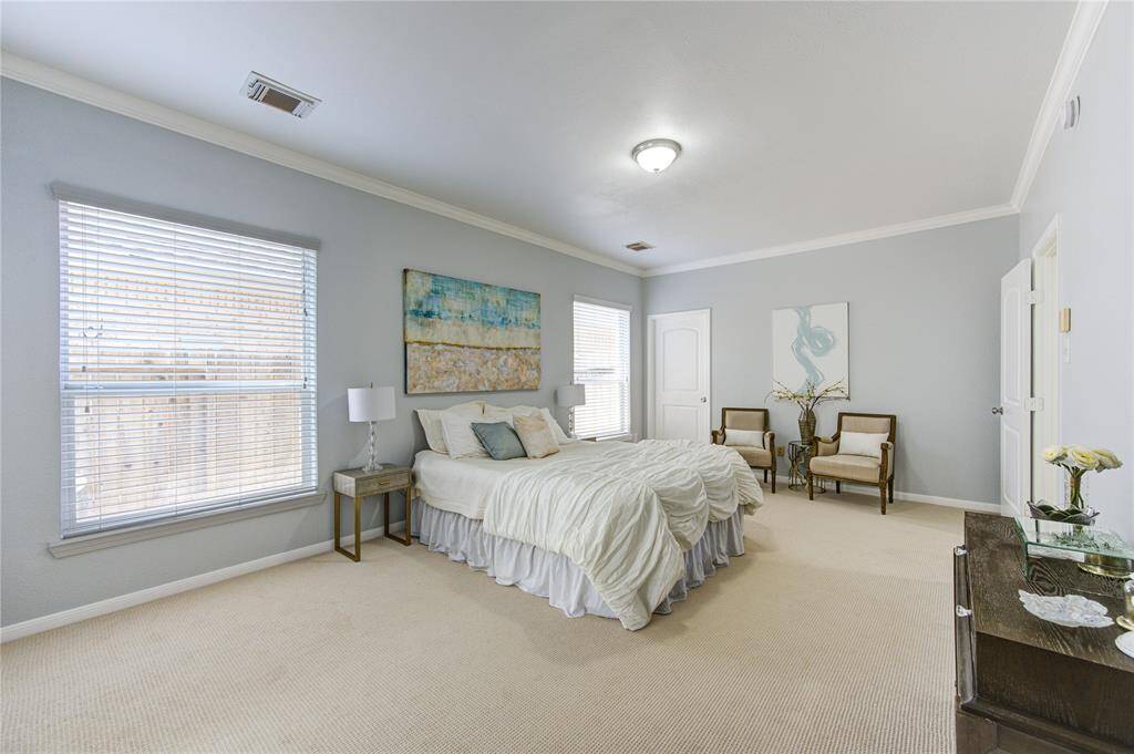The primary bedroom is a luxurious retreat with a generous floor plan that allows for a variety of furniture configurations whether you wish to zone out a reading nook or a vanity station.