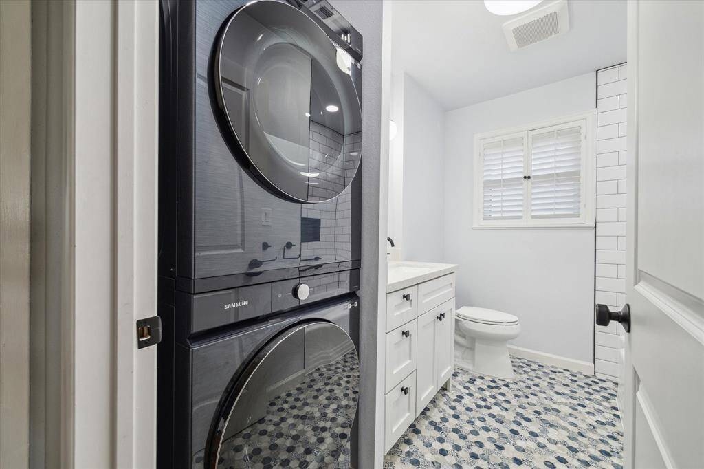 The stylish full bathroom sits between the two secondary bedrooms and houses the brand new washer and dryer, which are included in the purchase the home.