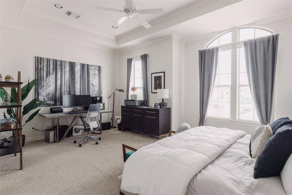 Primary bedroom with a large sitting area that is currently being used as an office